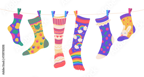 Cute socks on a rope with colored clothespins, knee socks hang it with clothespins, vector funny children's footwear