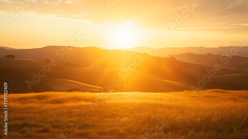 Dramatic sunset over a rolling hills landscape with long shadows and a golden sky. © Finsch