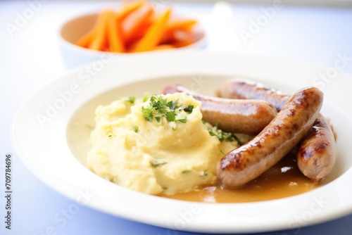 bangers and mash meal with steamed carrots