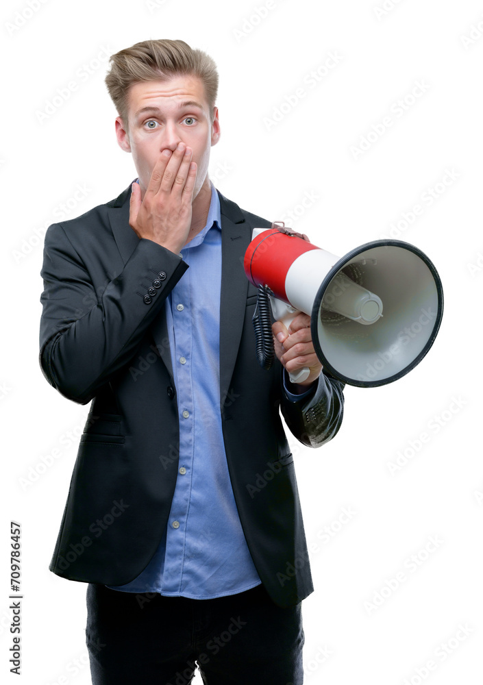 Young handsome blond man holding a megaphone cover mouth with hand shocked with shame for mistake, expression of fear, scared in silence, secret concept Young handsome blond man holding a megaphone cover mouth with hand shocked with shame for mistake, expression of fear, scared in silence, secret concept