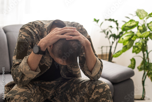 A distraught soldier covering his face, possibly suffering from shell shock or Post Traumatic Stress Disorder © Angelov