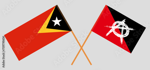 Crossed flags of East Timor and anarchy. Official colors. Correct proportion