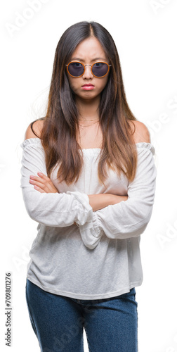 Young asian woman wearing sunglasses over isolated background skeptic and nervous  disapproving expression on face with crossed arms. Negative person.