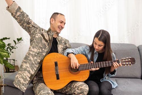 a veteran and his daughter play the guitar