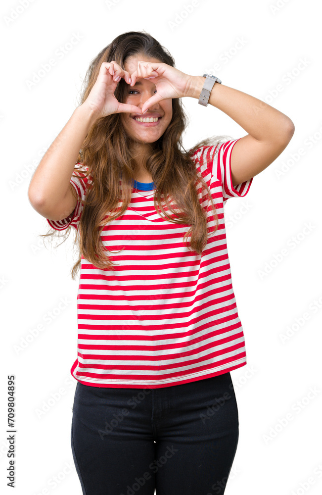 Young beautiful brunette woman wearing stripes t-shirt over isolated background Doing heart shape with hand and fingers smiling looking through sign Young beautiful brunette woman wearing stripes t-shirt over isolated background Doing heart shape with hand and fingers smiling looking through sign