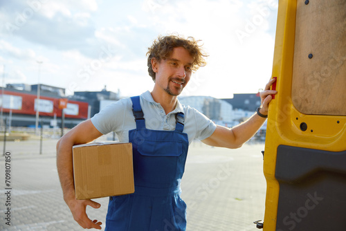 Courier closing delivery van after shipment inspecting before transportation photo