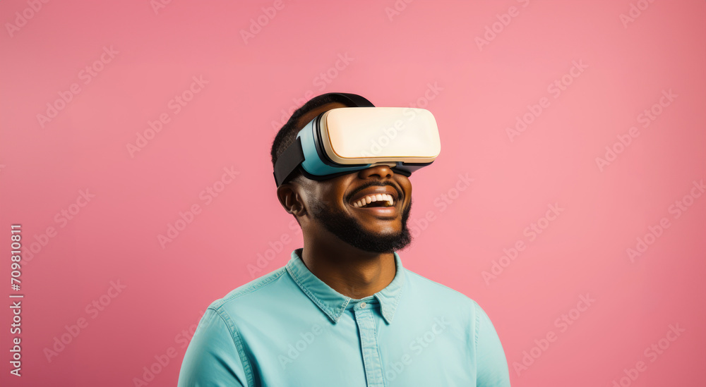 Young African American male using VR and smiling glasses over pink background with copy space