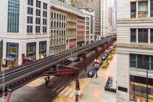Elevated rail tracks lined with traditional architecture in Chicago downtown on a rainy spring day photo