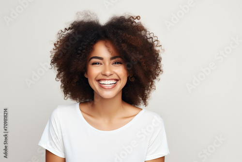 Black woman smiling in a studio © Volodymyr