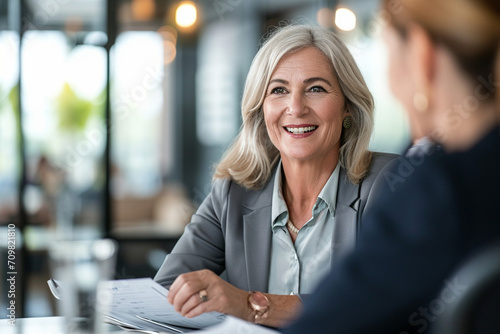 Confident Mature Businesswoman in Corporate Setting Engaging in Professional Consultation, Holding CV with a Pleasant Demeanor, Legal Advisor at Work, Employment Expert Discussing Career Opportunities