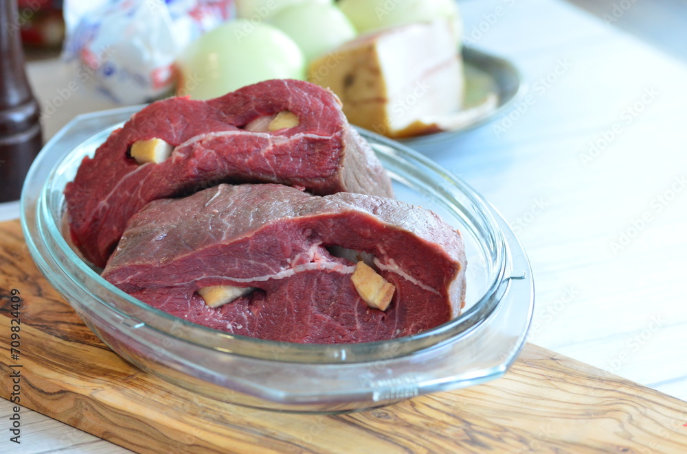 raw meat on a white background in a glass container, close-up raw meat on a white background in a glass container, close-up