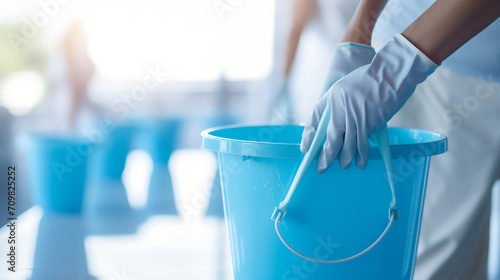 close up photography of a hand holding a light blue bucket for cleaning created with Generative Ai photo