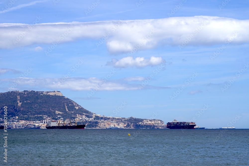 Fully loaded container ship and other ships anchor in the Bay of Gibraltar, logistic, Gibraltar, Rock of Gibraltar, sea freight, economy