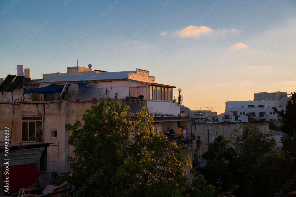 Dusk over Neve Shaanan: An urban sunset view of South Tel Aviv's rustic charm and residential character, hinting at local life.