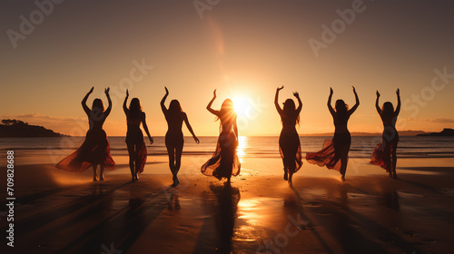 Group of happy young friends are having fun and embracing at sunset beach