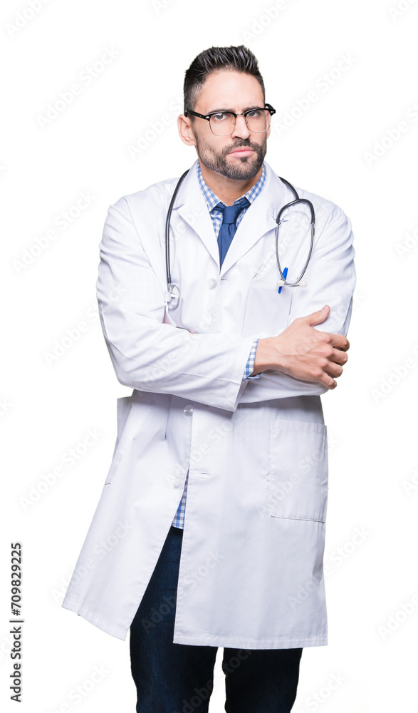 Handsome young doctor man over isolated background skeptic and nervous, disapproving expression on face with crossed arms. Negative person. Handsome young doctor man over isolated background skeptic and nervous, disapproving expression on face with crossed arms. Negative person.