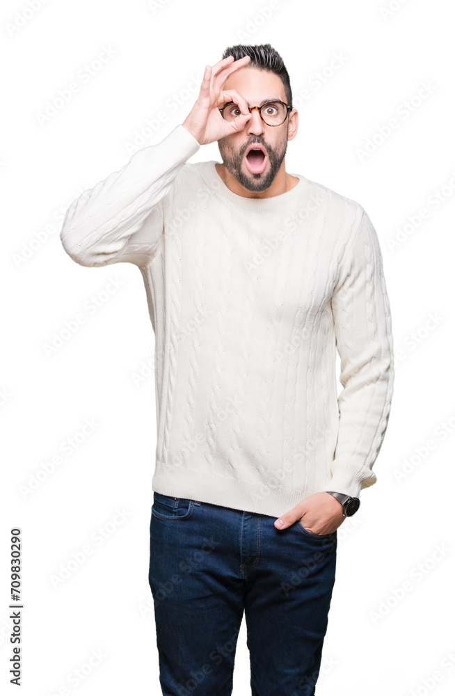 Young handsome man wearing glasses over isolated background doing ok gesture shocked with surprised face, eye looking through fingers. Unbelieving expression. Young handsome man wearing glasses over isolated background doing ok gesture shocked with surprised face, eye looking through fingers. Unbelieving expression.