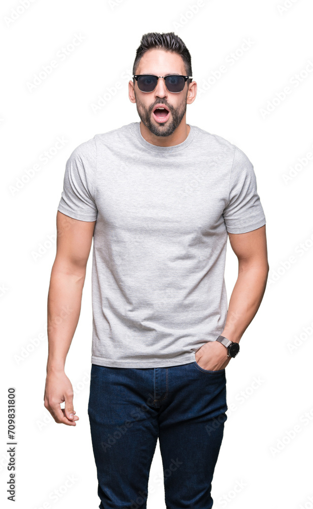Fototapeta premium Young handsome man wearing sunglasses over isolated background scared in shock with a surprise face, afraid and excited with fear expression
