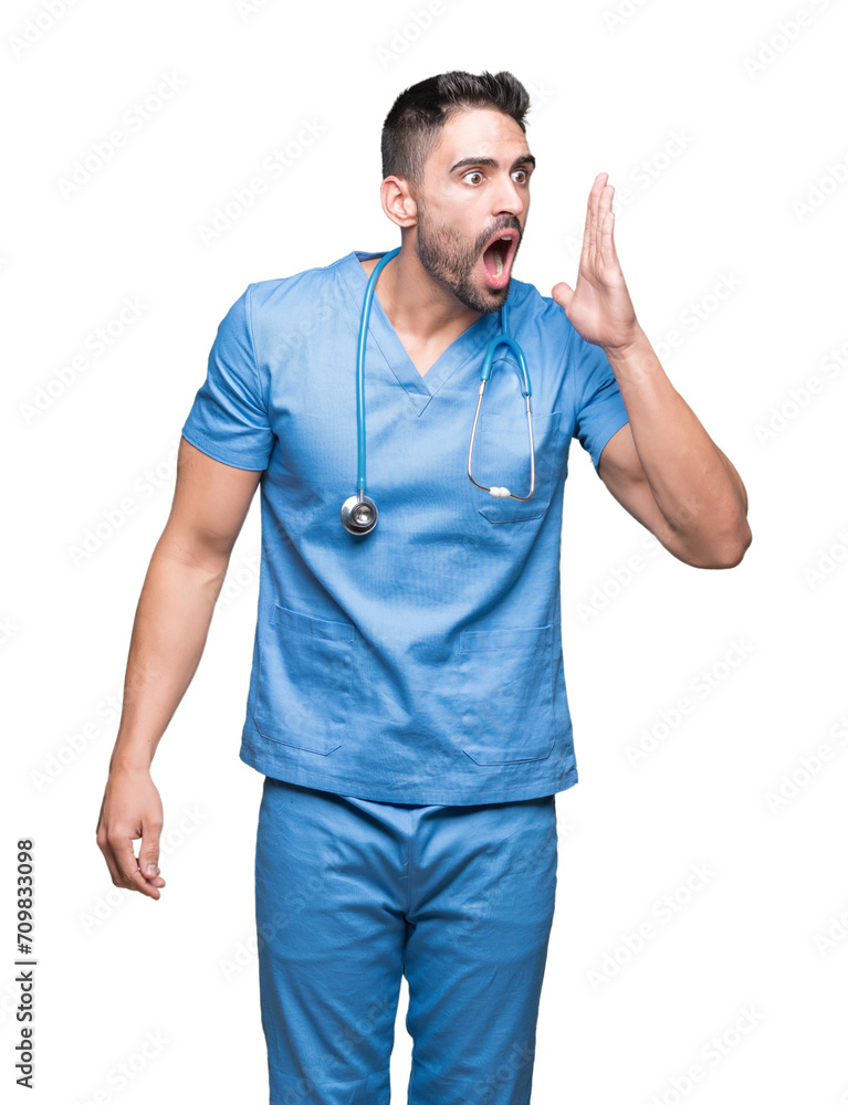 Handsome young doctor surgeon man over isolated background shouting and screaming loud to side with hand on mouth. Communication concept. Handsome young doctor surgeon man over isolated background shouting and screaming loud to side with hand on mouth. Communication concept.