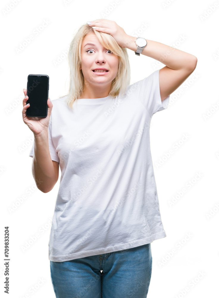 Young beautiful blonde woman showing screen of smartphone over isolated background stressed with hand on head, shocked with shame and surprise face, angry and frustrated. Fear and upset for mistake. Young beautiful blonde woman showing screen of smartphone over isolated background stressed with hand on head, shocked with shame and surprise face, angry and frustrated. Fear and upset for mistake.