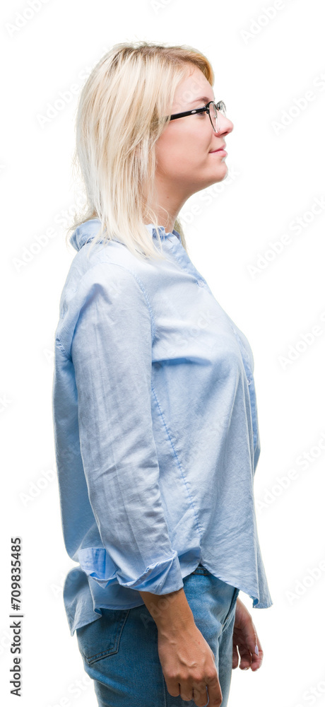 Young beautiful blonde business woman wearing glasses over isolated background looking to side, relax profile pose with natural face with confident smile. Young beautiful blonde business woman wearing glasses over isolated background looking to side, relax profile pose with natural face with confident smile.