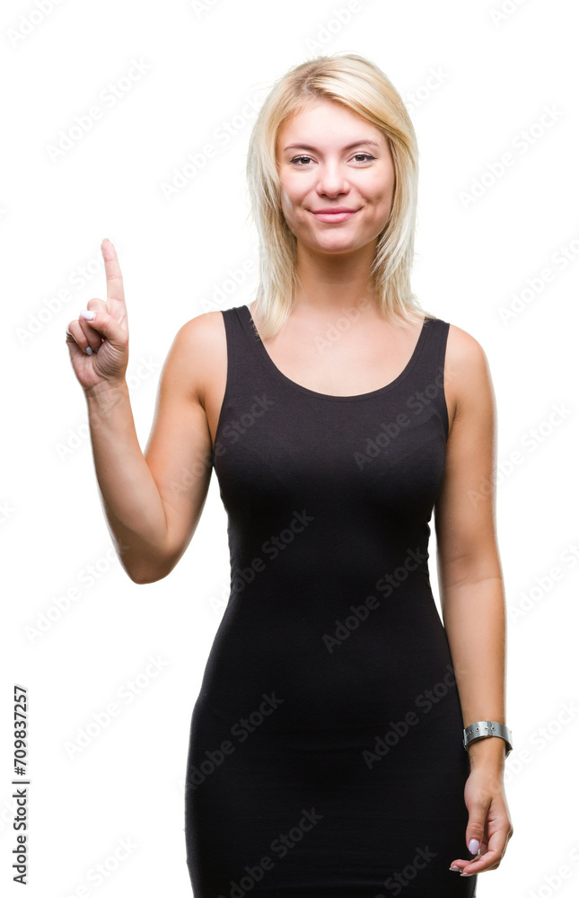 Fototapeta premium Young beautiful blonde attractive woman wearing elegant dress over isolated background showing and pointing up with finger number one while smiling confident and happy.