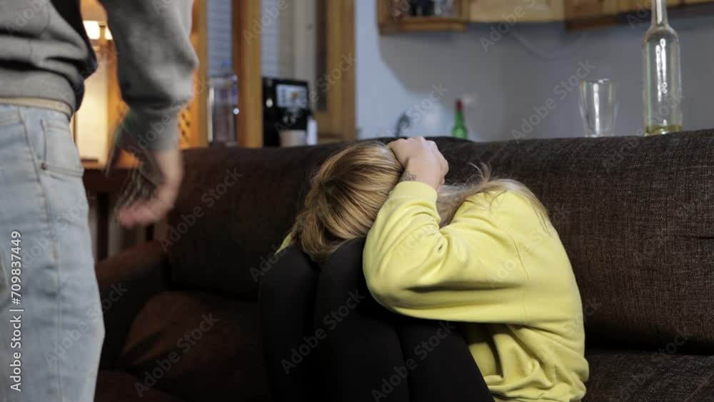 Man clenching his fist, cinematic concept of domestic violence. girl covers her face man hits Man clenching his fist, cinematic concept of domestic violence. girl covers her face man hits