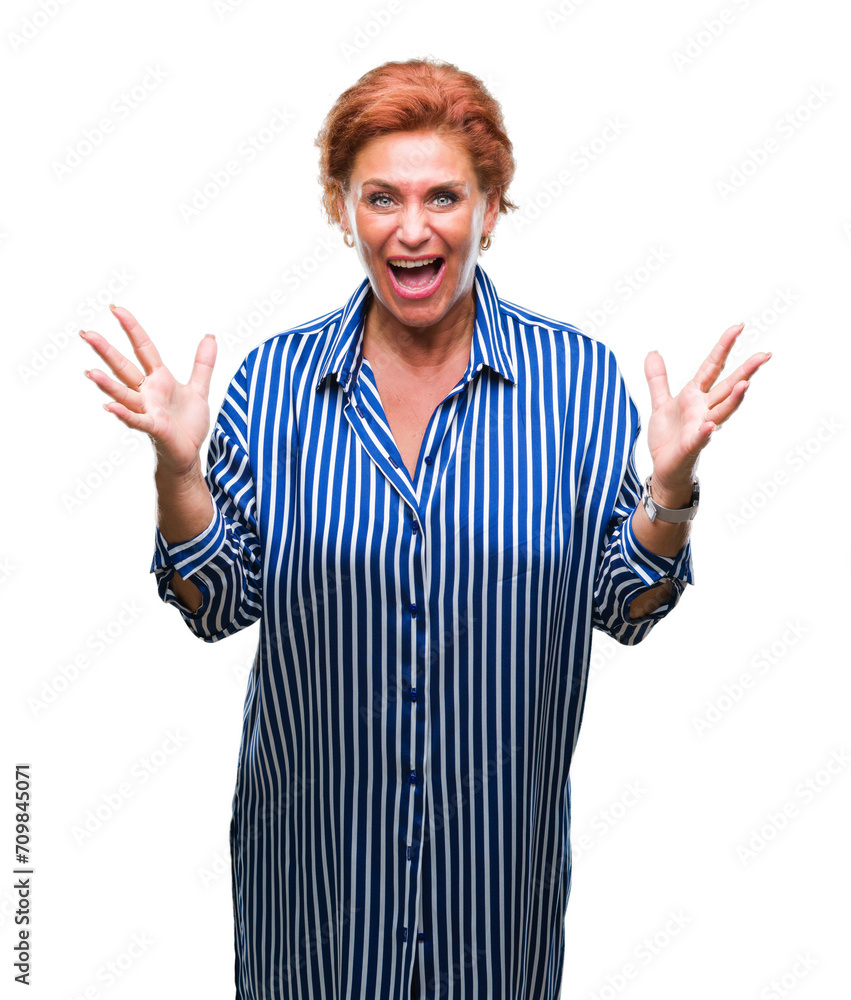 Atrractive senior caucasian redhead woman over isolated background celebrating crazy and amazed for success with arms raised and open eyes screaming excited. Winner concept Atrractive senior caucasian redhead woman over isolated background celebrating crazy and amazed for success with arms raised and open eyes screaming excited. Winner concept