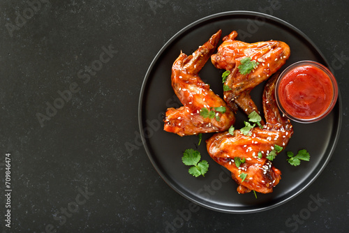 Baked chicken wings on plate photo