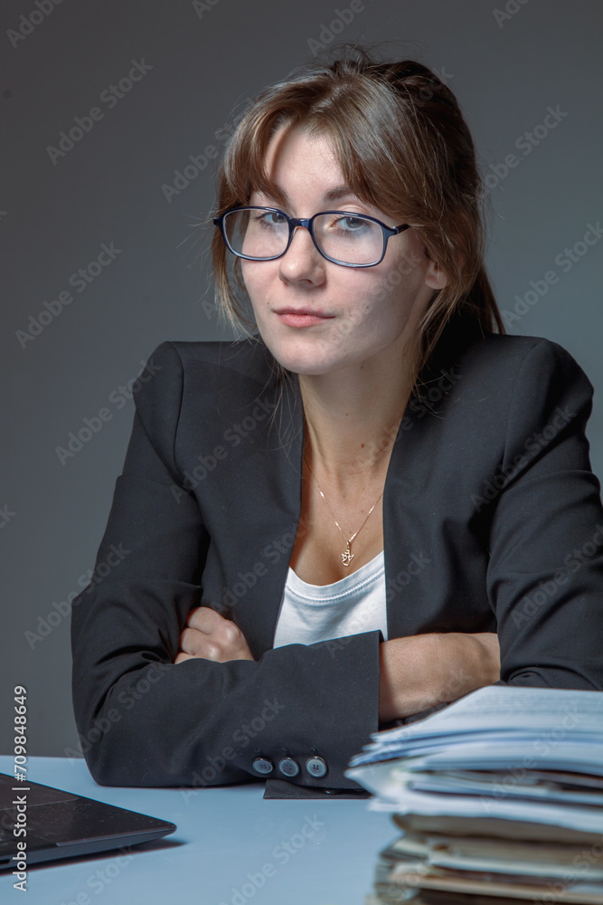 Young female office employee working with documents. High salaries, career development, prospects. Young female office employee working with documents. High salaries, career development, prospects.