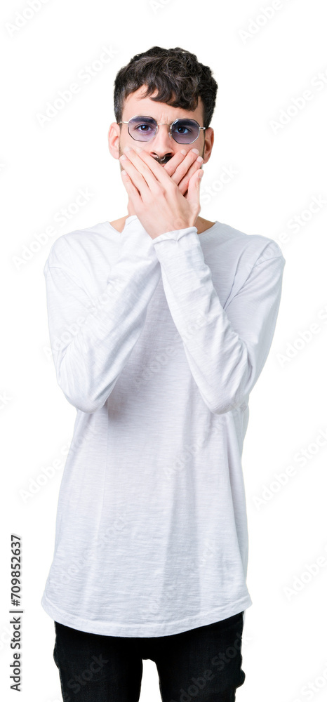 Young handsome man wearing sunglasses over isolated background shocked covering mouth with hands for mistake. Secret concept. Young handsome man wearing sunglasses over isolated background shocked covering mouth with hands for mistake. Secret concept.