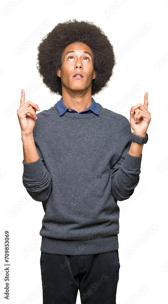 Young african american business man with afro hair amazed and surprised looking up and pointing with fingers and raised arms. Young african american business man with afro hair amazed and surprised looking up and pointing with fingers and raised arms.