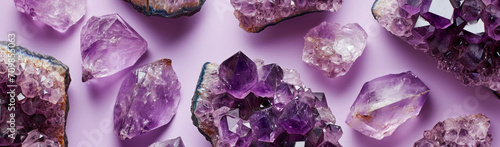 Amethyst crystals banner, beautiful shiny purple gemstones close-up luxury background. Concepts of precious gems and minerals collection, spirituality and healing.