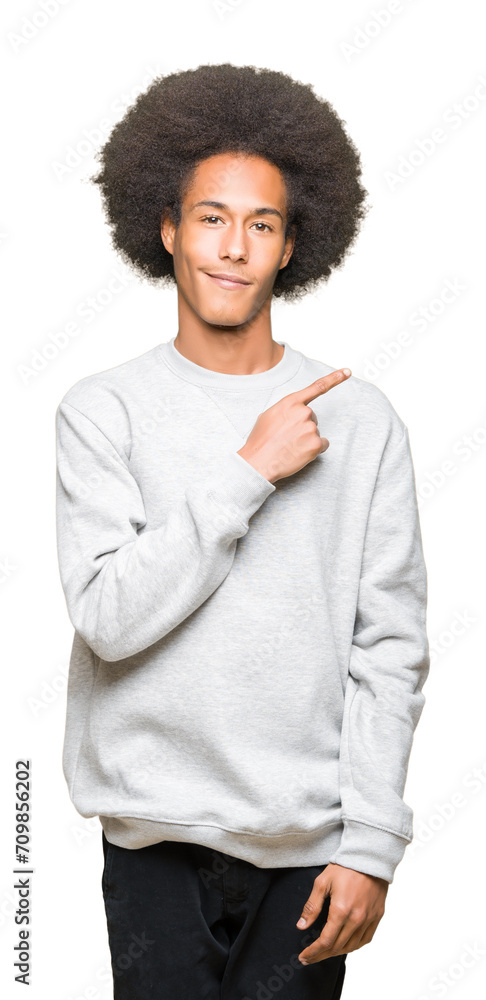 Young african american man with afro hair wearing sporty sweatshirt Pointing with hand finger to the side showing advertisement, serious and calm face Young african american man with afro hair wearing sporty sweatshirt Pointing with hand finger to the side showing advertisement, serious and calm face