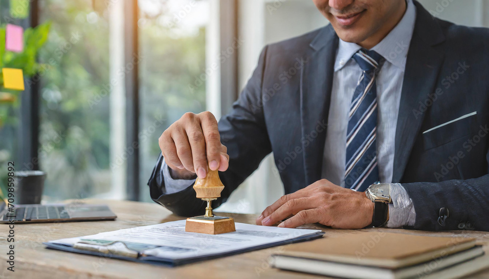 Closed up businessman hand using wooden stamping to document approve and reject document or project concept, copy space. Closed up businessman hand using wooden stamping to document approve and reject document or project concept, copy space.