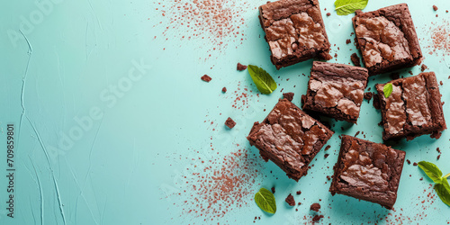Top view Mint Chocolate Brownies. Rich chocolate brownies with creme de menthe, garnished with fresh mint leaves on kitchen background with copy space. photo