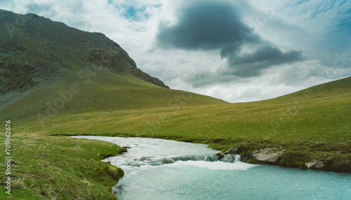 Minimalist landscape with a mountain stream and a cloudy sky