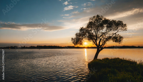 Minimalist photo of a sunset over river with a tree