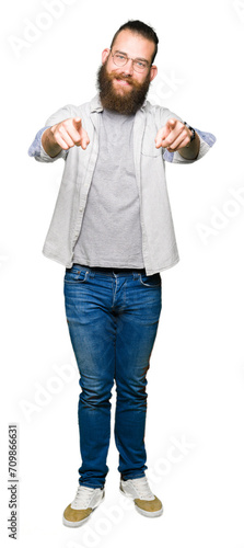 Young blond man wearing glasses Pointing to you and the camera with fingers, smiling positive and cheerful © Krakenimages.com