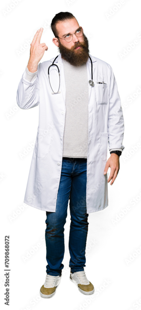 Young blond doctor man with beard wearing medical coat Shooting and killing oneself pointing hand and fingers to head, suicide gesture.