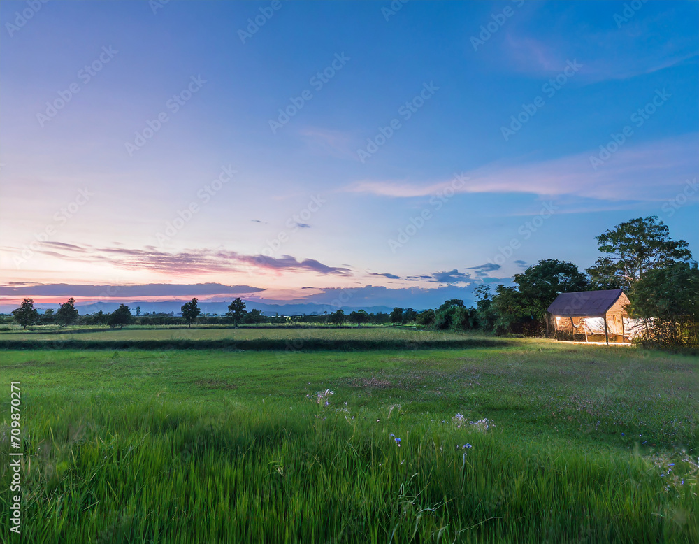 beautiful meadow with clear sky and countryside house at dusk beautiful meadow with clear sky and countryside house at dusk