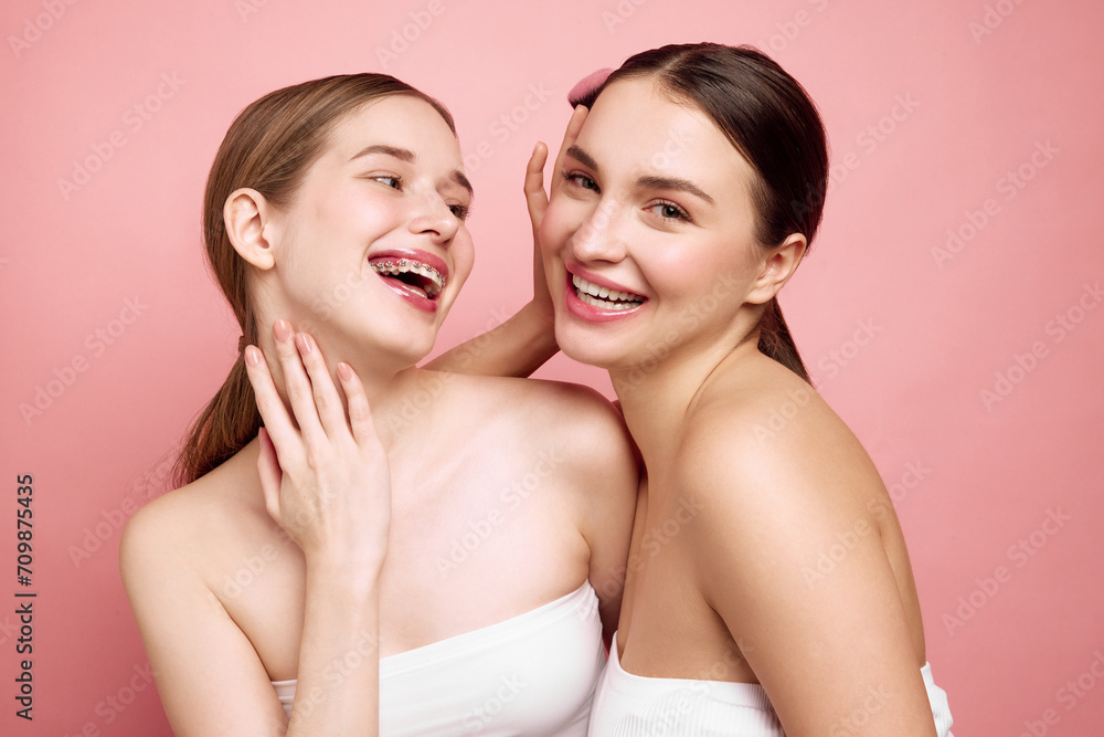 Unveiling true beauty together. Portrait of two positive, charming young ladies. Focusing on art of capturing expressive and detailed human faces. Concept of self care, beauty products, wellness, spa. Unveiling true beauty together. Portrait of two positive, charming young ladies. Focusing on art of capturing expressive and detailed human faces. Concept of self care, beauty products, wellness, spa.