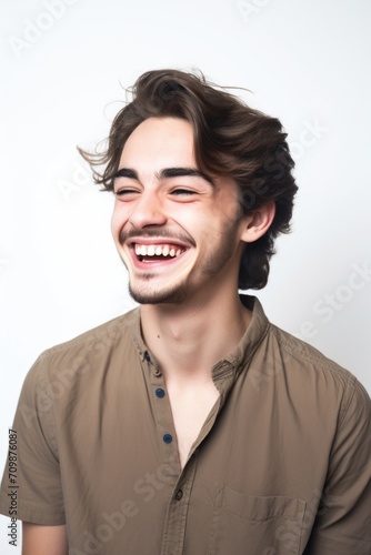 studio shot of a cheerful young man against a white background © Sergey