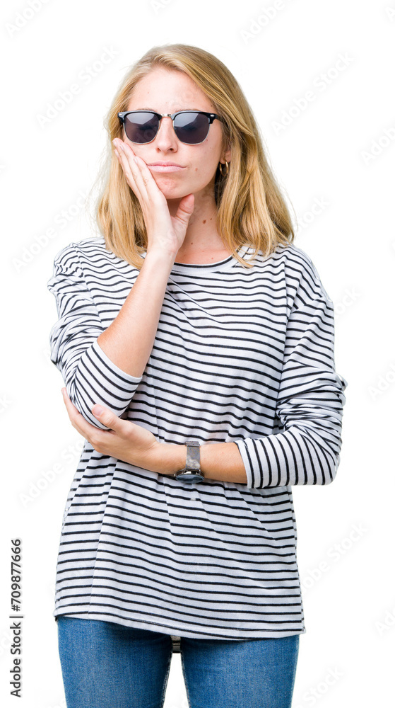 Beautiful young woman wearing sunglasses over isolated background thinking looking tired and bored with depression problems with crossed arms. Beautiful young woman wearing sunglasses over isolated background thinking looking tired and bored with depression problems with crossed arms.