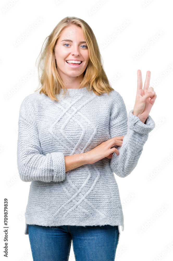Beautiful young woman wearing winter sweater over isolated background smiling with happy face winking at the camera doing victory sign. Number two. Beautiful young woman wearing winter sweater over isolated background smiling with happy face winking at the camera doing victory sign. Number two.