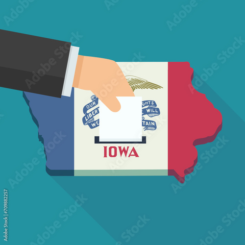 3D map of Iowa in the colors of the Iowa State flag in a flat design style isolated on a blue background with a shadow in which a hand places a ballot paper photo