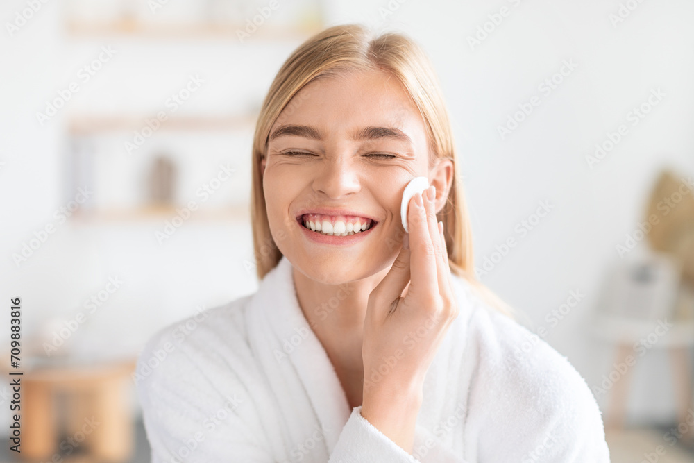 Funny Blonde Woman Doing Facial Skincare With Cotton Pad Indoors Funny Blonde Woman Doing Facial Skincare With Cotton Pad Indoors