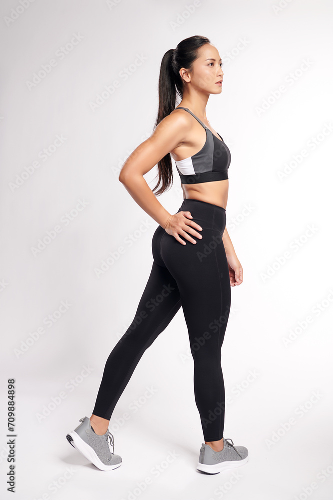 an asian woman is working out wearing the sport exercise suit with white background, an asian woman is working out wearing the sport exercise suit with white background,