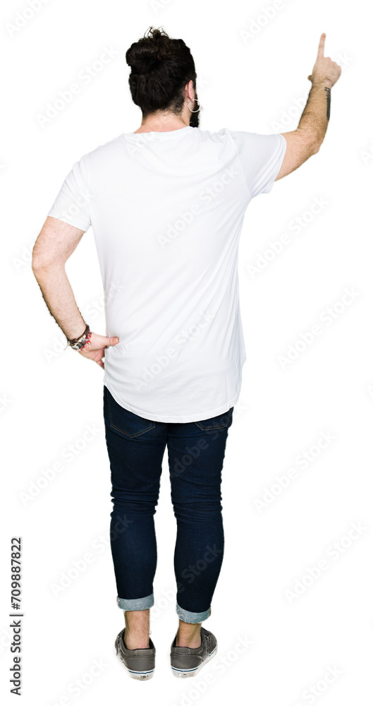 Young hipster man with long hair and beard wearing casual white t-shirt Posing backwards pointing behind with finger hand Young hipster man with long hair and beard wearing casual white t-shirt Posing backwards pointing behind with finger hand