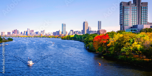 Vibrant Boston City Skyline Panorama with Skyscrapers, Curving Blue Charles River, Colorful Autumn Foliage, and Kayakers in Massachusetts, USA, a tranquil metropolitan lifestyle photo
